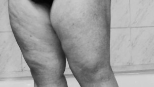 Chubby MILF shaves her pussy in the shower – black and white